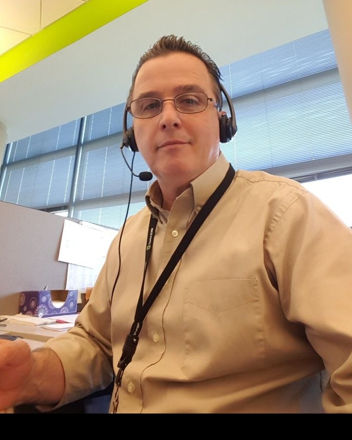 Customer service specialist wearing a headset at his desk